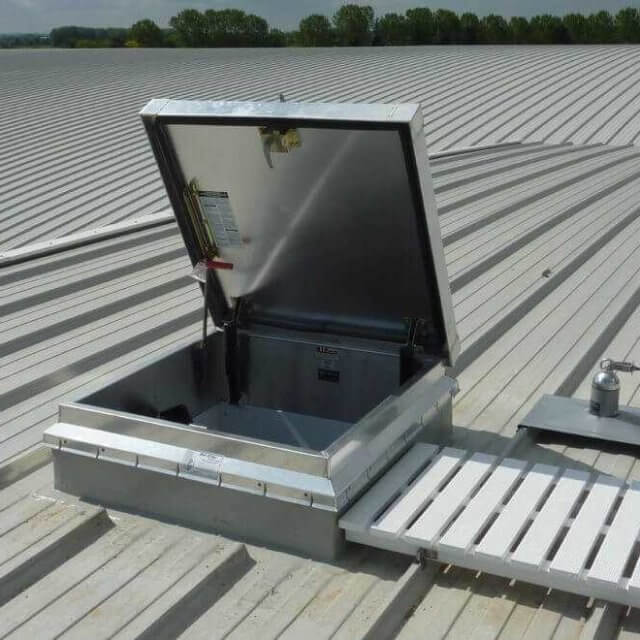 Bilco access hatch with a white walkway on a weatherproofed roof